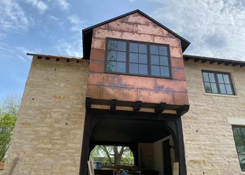 Copper metal panel facade on a stone building for Skylight Installation in Yorba Linda